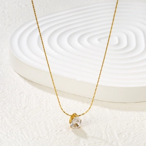 Elegant gold stainless steel necklace featuring a teardrop zircon pendant on white stage