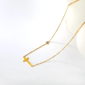 Minimalist 18k gold plated stainless steel cross necklace with a bright zircon stone