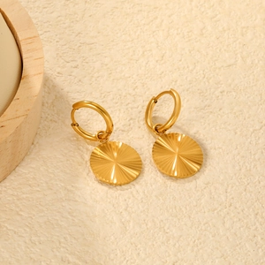 Gros plan de boucles d'oreilles cœur plaquées or 18K avec texture soleil ciselée