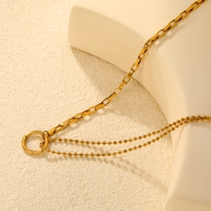 Minimalist gold stainless steel layered necklace featuring a geometric square link and beads