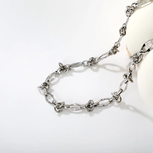 Silver cuban chain necklace in stainless steel with industrial knot design elements