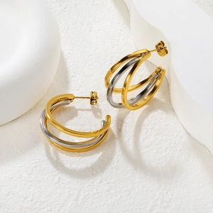 Minimalist geometric C-shaped hoop earrings with intertwined gold and silver triple bands