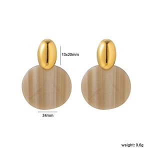 Detail view of oval gold metal studs with marble texture round pendants and dimensions