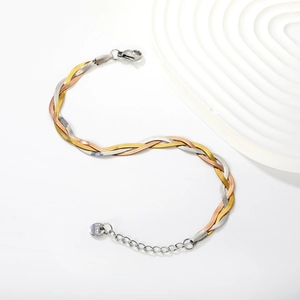 Detail of three-tone braided snake chain bracelet in gold, silver and rose gold finish