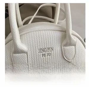 Detailed close-up of white lychee pattern leather handbag with precise stitching detail