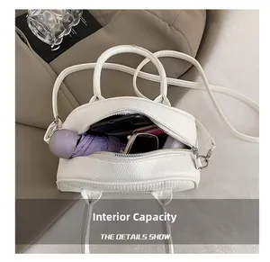 French shell bag interior showing capacity for umbrella, phone and wallet items