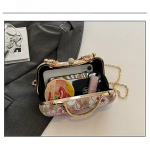 Detail view of the vintage evening bag interior showing capacity for phone and cosmetics