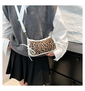 Detail of leopard print vintage bag with white leather trim and side bow accents