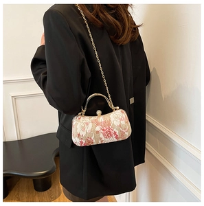 Detail of floral evening box bag with rose print and sparkling rhinestone clasp lock