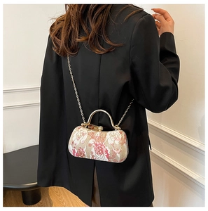 Detail of vintage floral jacquard box bag with pearl rhinestone clasp and gold handle