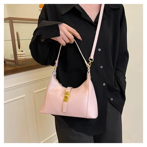 Detail of light pink dumpling bag with diamond stitching and golden buckle closure