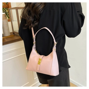 Detail of pink hobo bag featuring geometric texture and gold metallic clasp closure