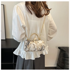 Detailed back view of vintage floral jacquard box bag with gold chain and handle