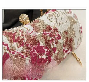 Close-up of vintage floral jacquard fabric and crystal-encrusted ball lock on the bag