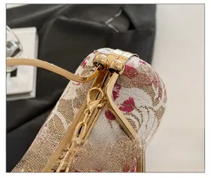 Close-up of gold flower clasp and sparkling rhinestones on the vintage evening bag