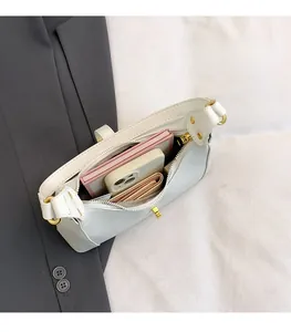 Top view of white hobo bag interior showing capacity for phone and notebook