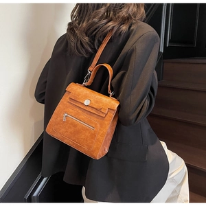 Brown vintage textured PU leather handbag with gold-tone hardware and crossbody strap detail