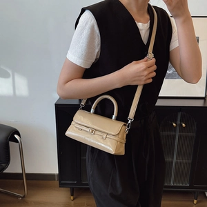 Chic beige patent leather mini square bag with decorative belt strap and top handle
