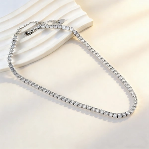 Elegant stainless steel tennis necklace with oval diamond clasp and heart charm