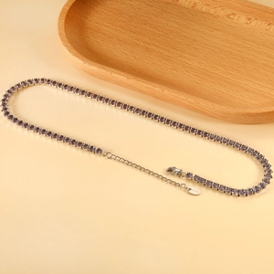 Macro detail of purple oval crystal tennis necklace with stainless steel clasp and S.STEEL tag