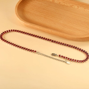 Macro detail of red stone tennis necklace with stainless steel lobster clasp and extension