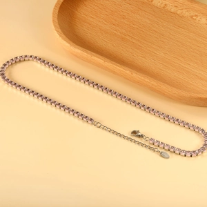 Detail of pink crystal tennis necklace with stainless steel lobster clasp and logo tag