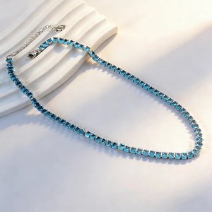 Detailed macro view of the sparkling blue zircon tennis necklace with lobster clasp