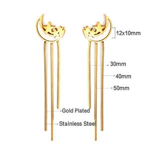 Detail showing gold plated stainless steel moon and star earrings with long snake chain tassels