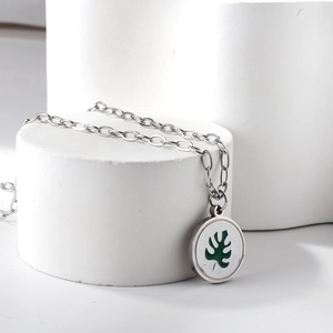 Détail du collier en acier inoxydable doré 18K avec pendentif feuille verte et nacre