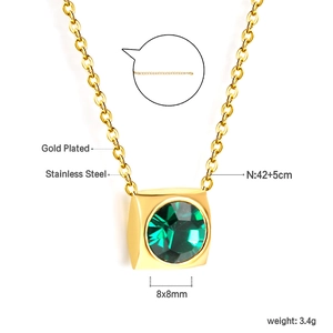 Macro detail of square gold-plated stainless steel pendant with green crystal stone