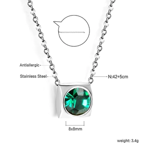 Detail of square silver stainless steel pendant necklace with a green faceted gemstone