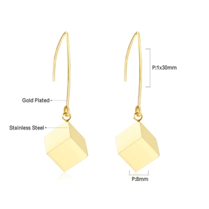 Detail view of 18k gold plated stainless steel drop earrings with 8mm cube pendant