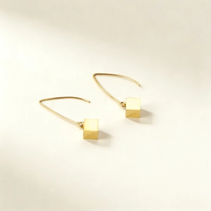 Minimalist gold square drop earrings featuring a geometric cube on long curved ear hooks