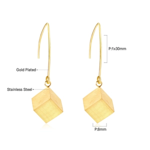 Macro detail of gold-plated square pendant earrings showing 8mm cube and 30mm hook