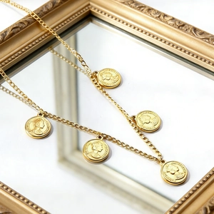 Vintage style gold plated stainless steel necklace featuring five queen coin pendants