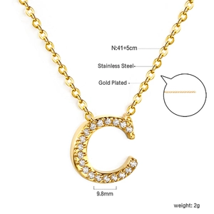 Macro view of C-letter pendant with sparkling zircons on 18K gold plated stainless steel chain