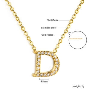 Detailed view of D-letter pendant necklace in 18K gold plated stainless steel with crystals