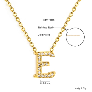 Macro shot of 18K gold plated letter E pendant with crystal inlay on stainless steel chain