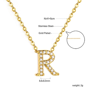 Macro detail of gold plated letter R pendant with white cubic zirconia and dimensions