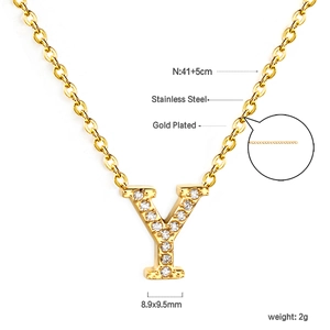 Macro detail of gold plated 18K stainless steel letter Y pendant with cubic zirconia stones