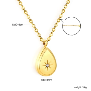 Detail of 18K gold-plated teardrop necklace with starburst zircon and extension chain