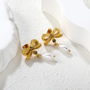 Vue détaillée de boucles d'oreilles papillon en or 18k avec perles et cristaux