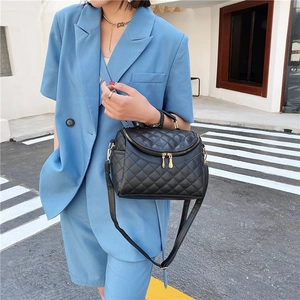 Chic black quilted PU leather handbag with gold zippers and adjustable shoulder strap