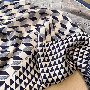 Detail shot of navy and cream geometric silk scarf featuring elegant diamond patterns