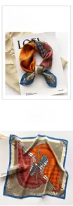 Detailed view of luxury silk scarf with equestrian horse print and rich satin texture