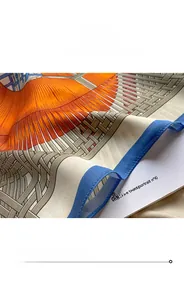 Close-up of fine overlock stitching on vibrant orange and grey silk scarf edges