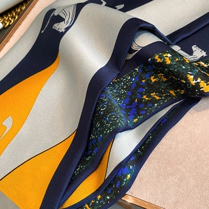 Macro detail of silk scarf showing vintage horse pattern and twill fabric texture