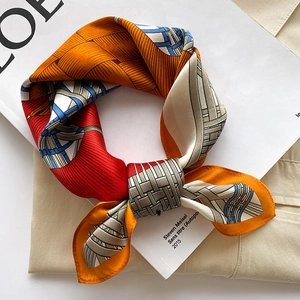 Silk square scarf with geometric weave pattern in vibrant orange and blue tones