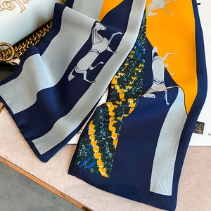Detailed view of vintage horse print skinny silk scarf with orange and navy color block