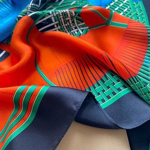 Detailed view of high-quality silk scarf fabric with glossy geometric patterns